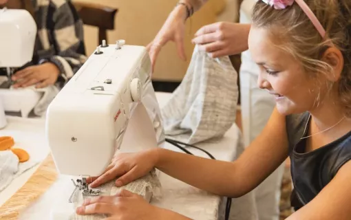 Girl and Teacher Sewing